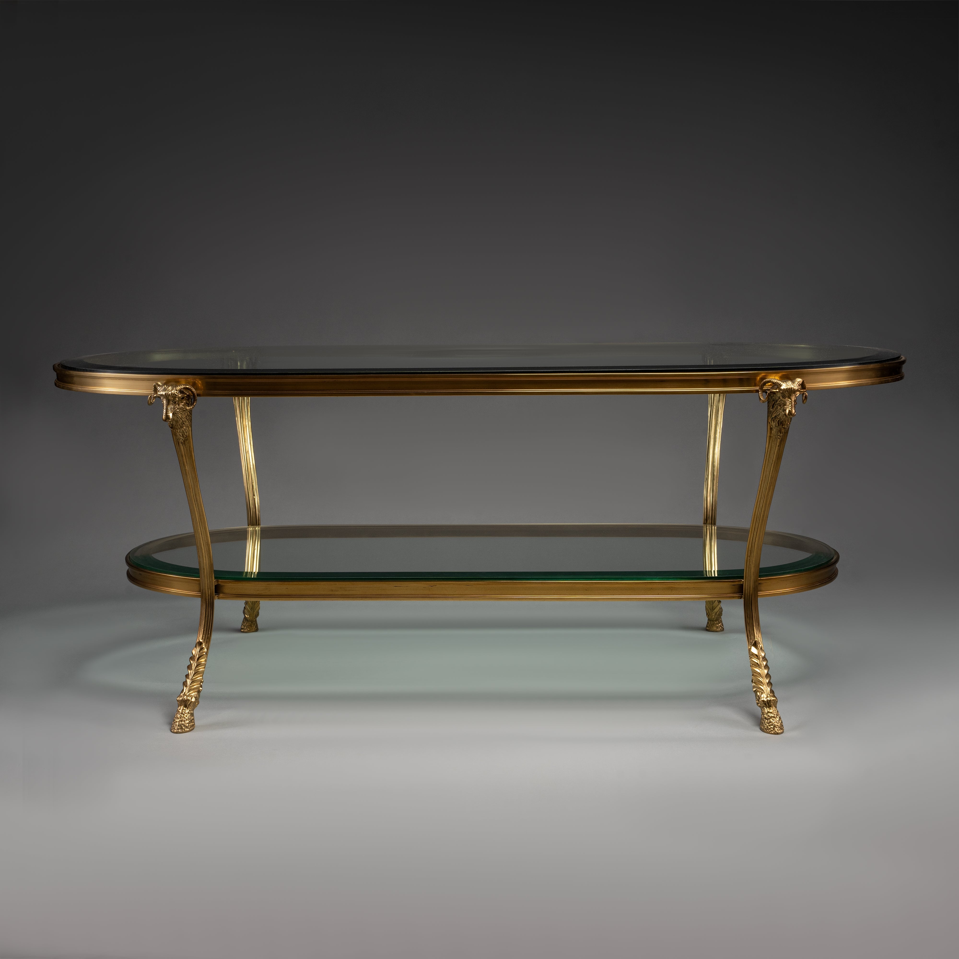 Oval Brass Coffee Table with Glass Shelves and Ram Head Accents