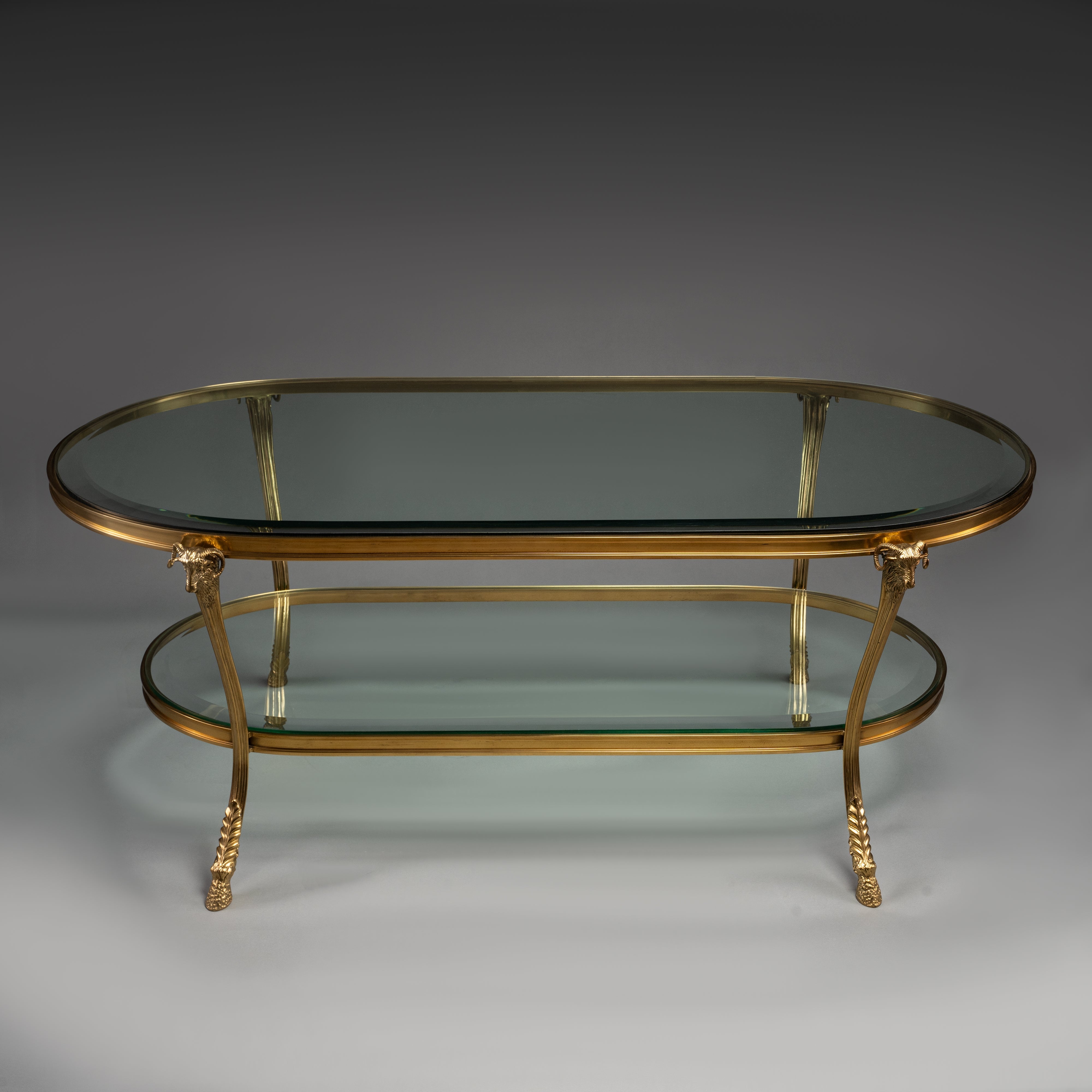 Oval Brass Coffee Table with Glass Shelves and Ram Head Accents
