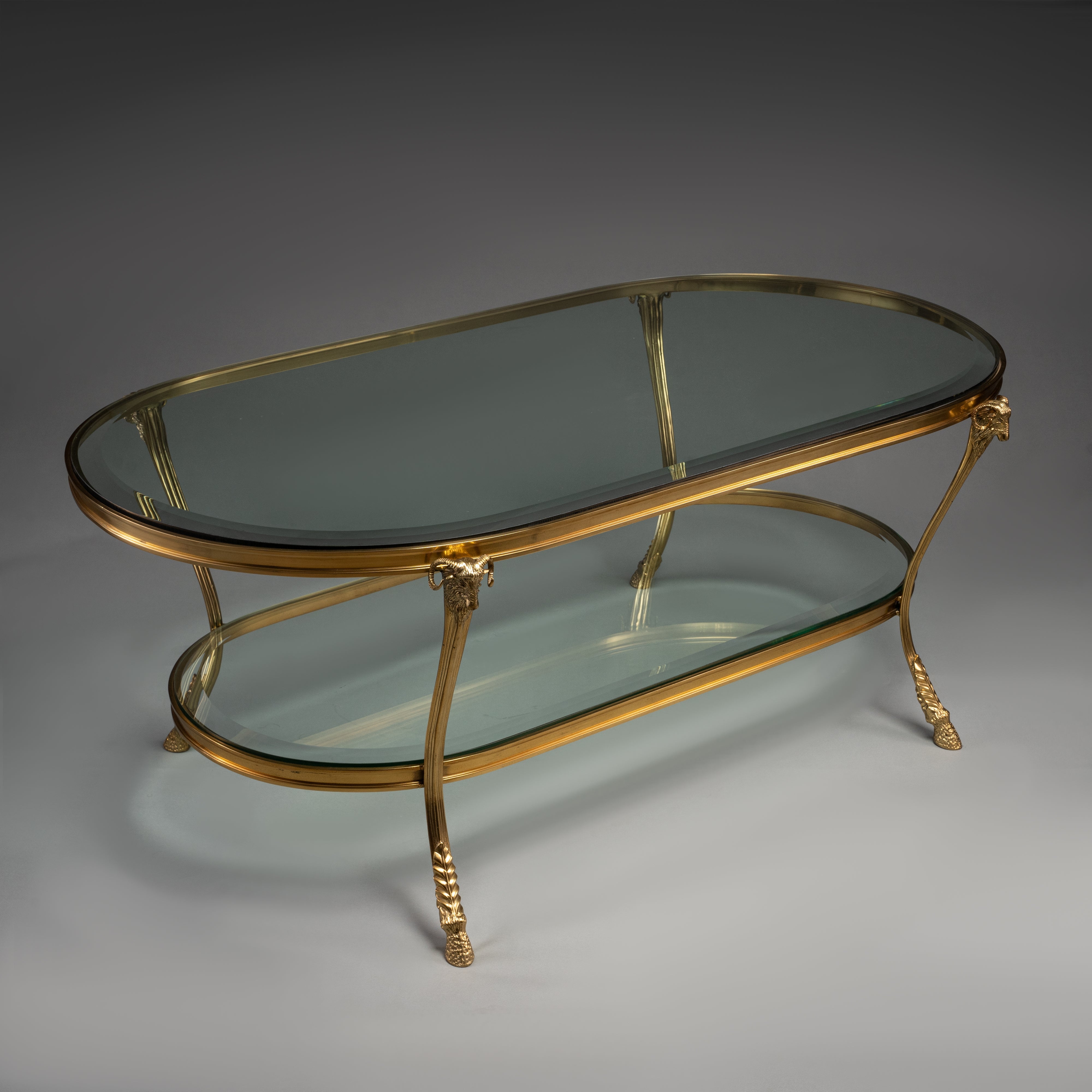 Oval Brass Coffee Table with Glass Shelves and Ram Head Accents