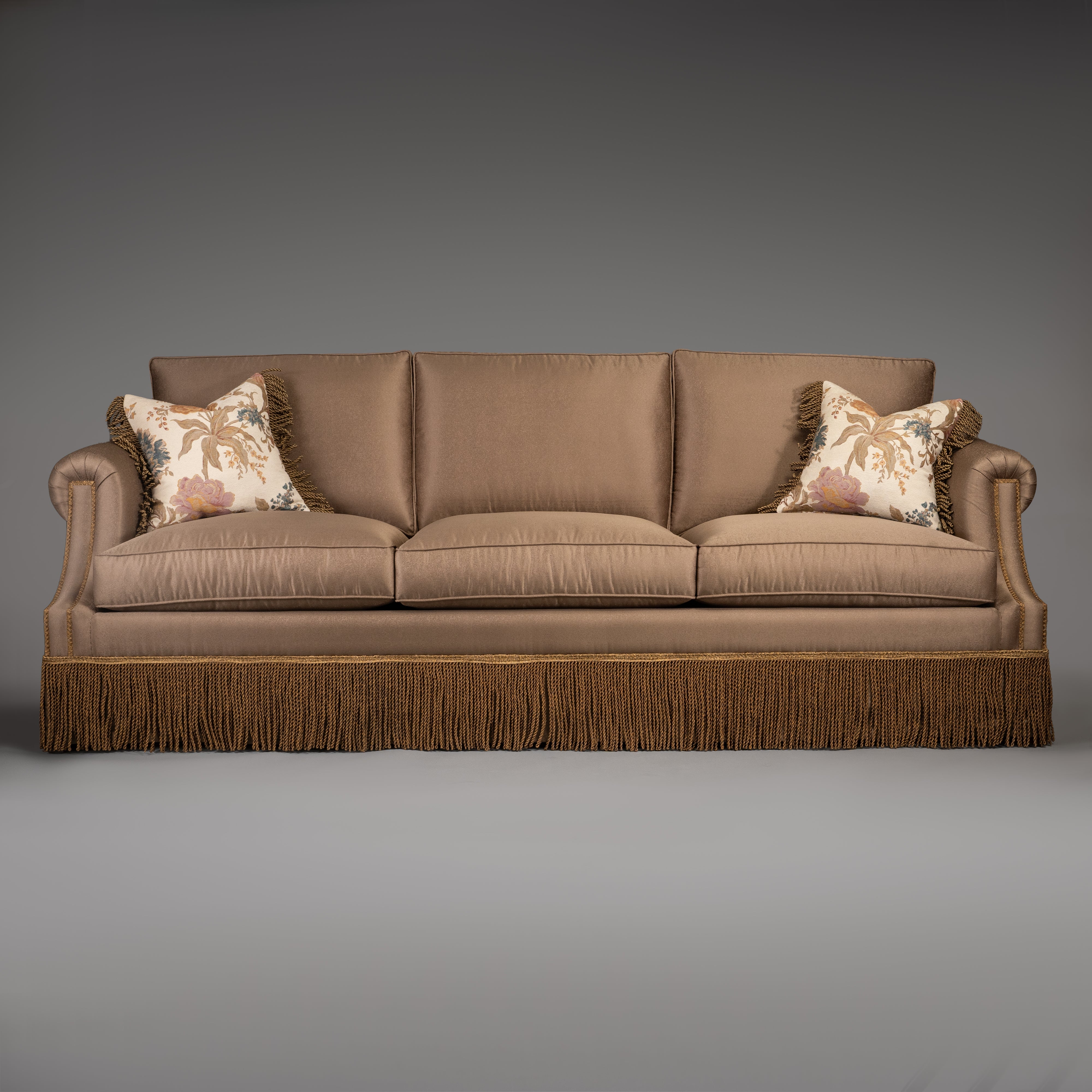 Classic Taupe Sofa with Rolled Arms and Decorative Fringe Skirt