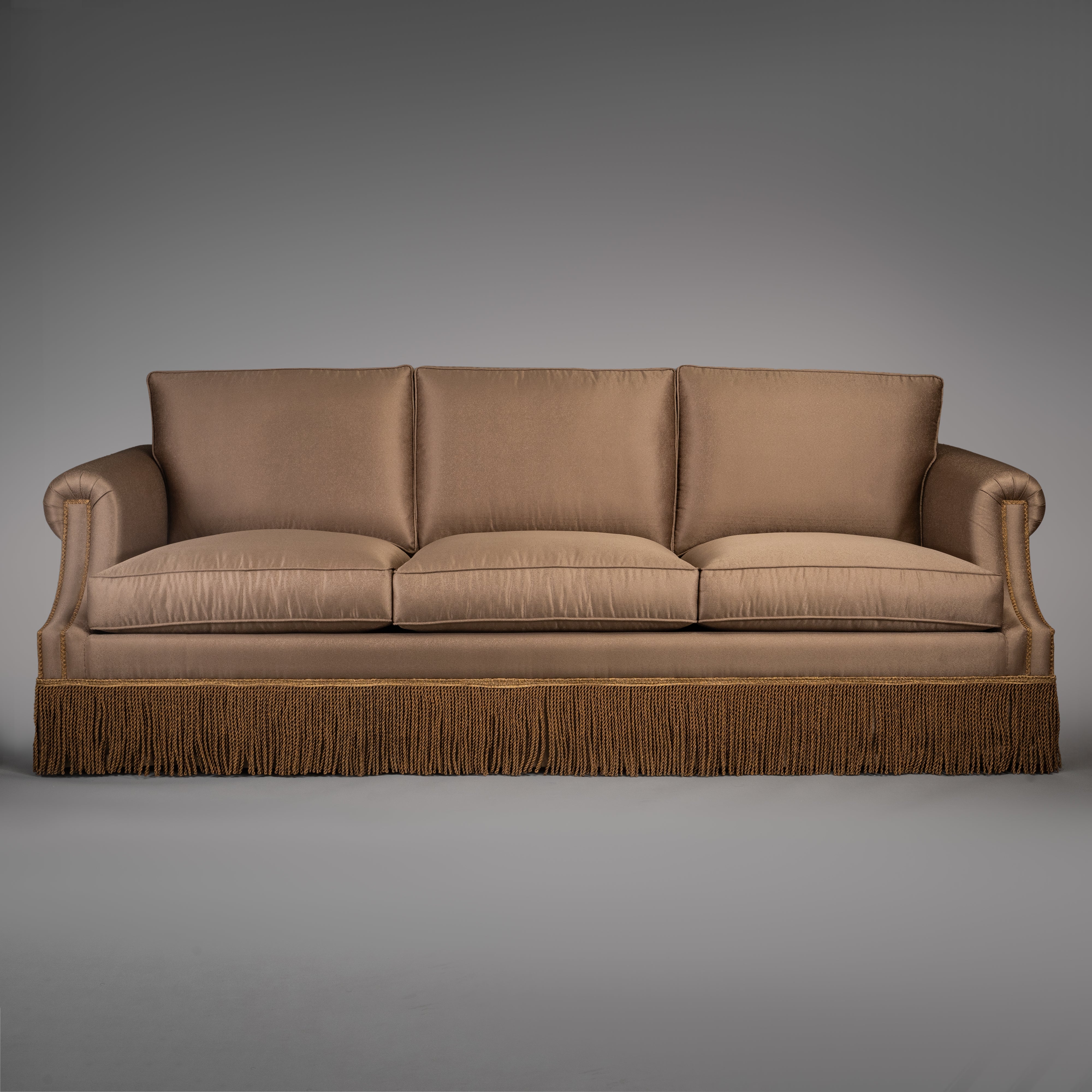 Classic Taupe Sofa with Rolled Arms and Decorative Fringe Skirt