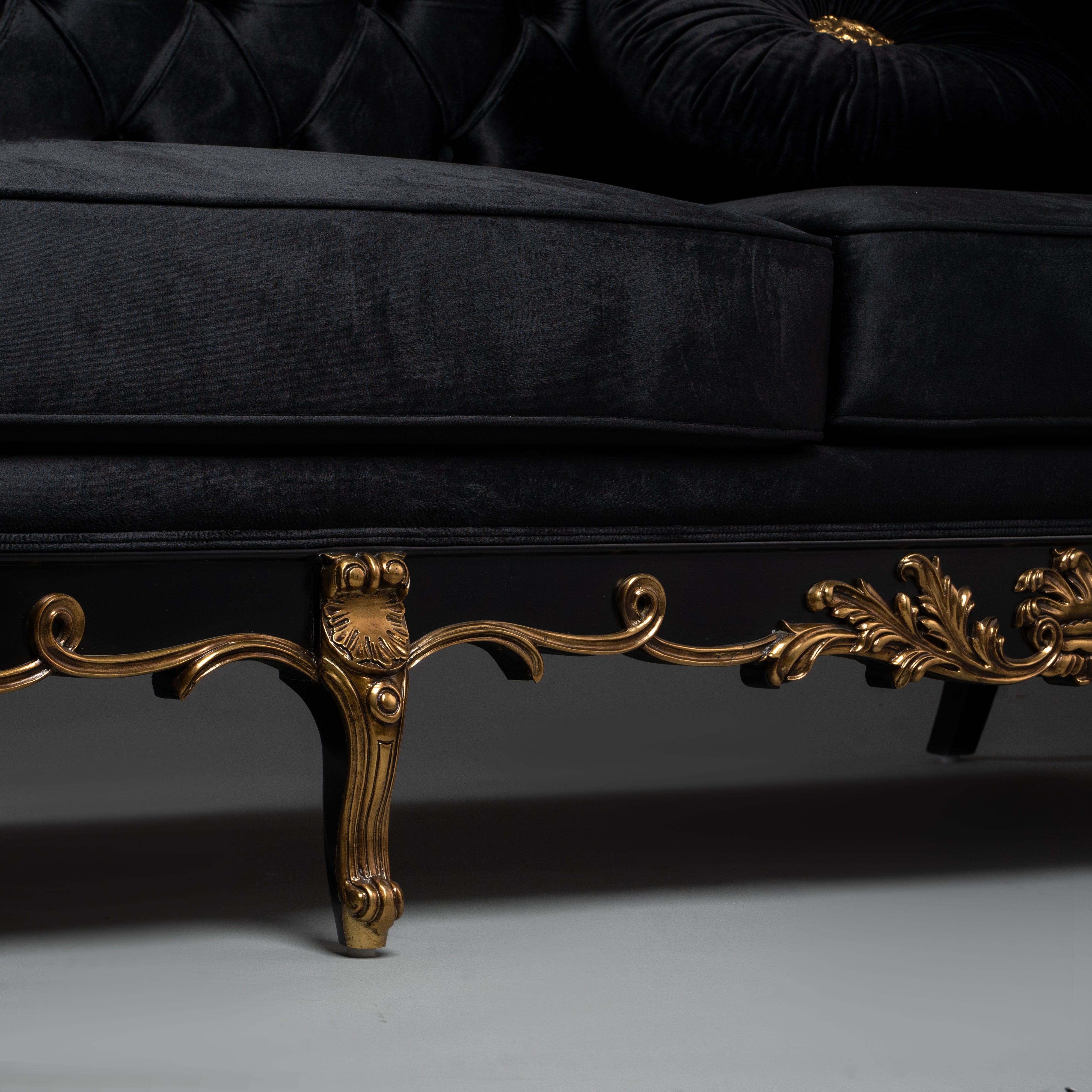Black Velvet Tufted Sofa with Ornate Brass Detailing