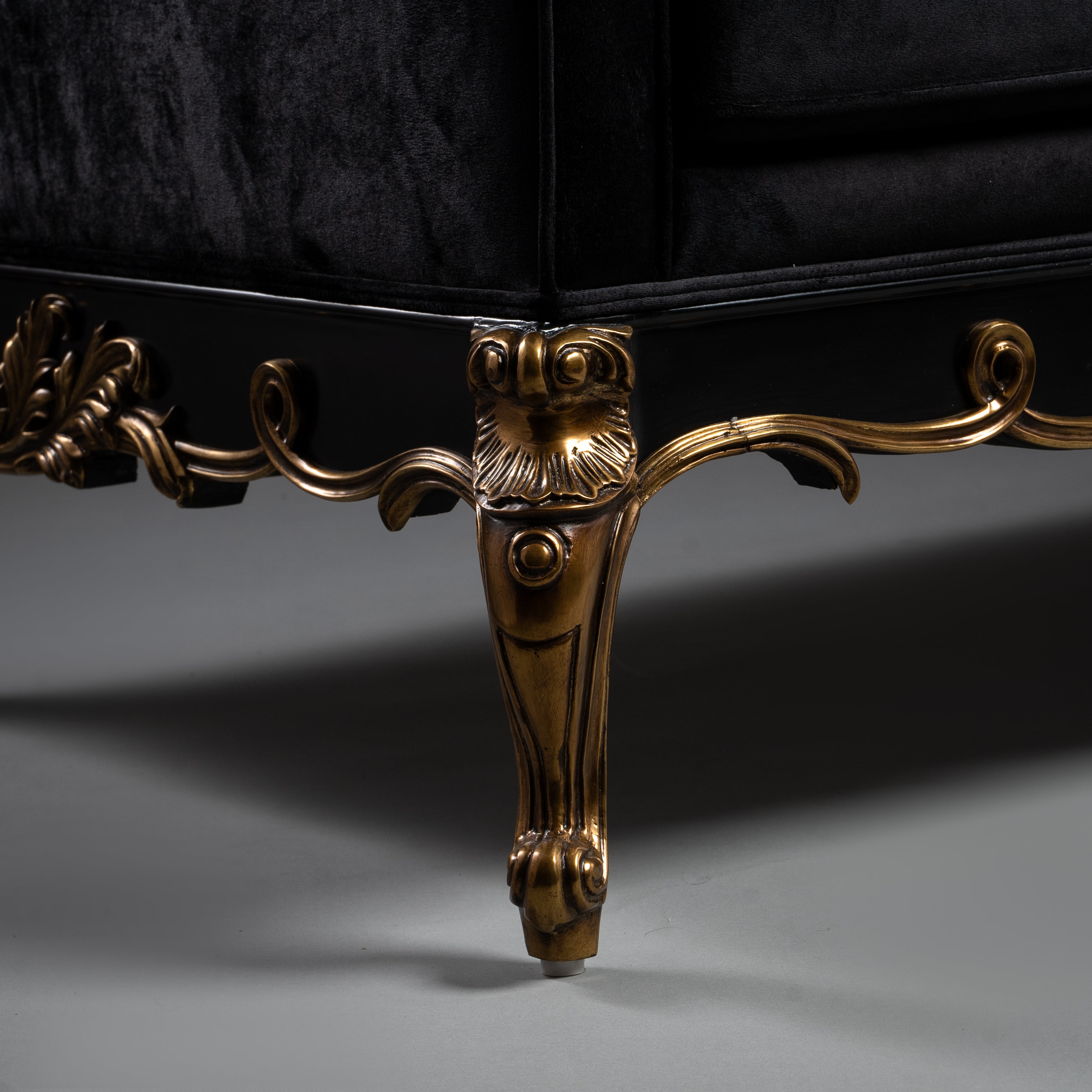 Black Velvet Tufted Sofa with Ornate Brass Detailing