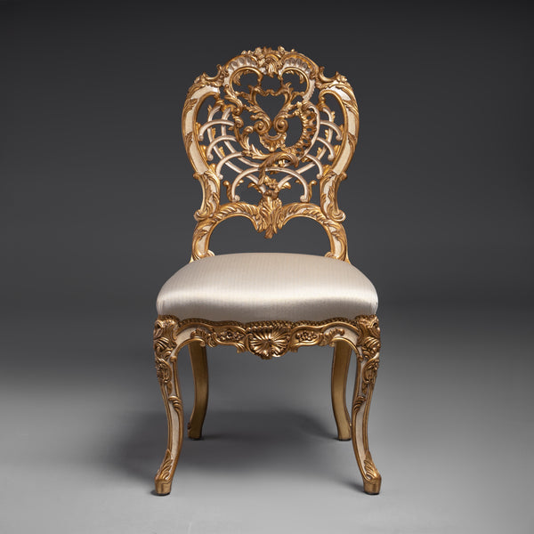 A masterpiece of baroque artistry, this gilded  chair features an intricately carved backrest  with opulent detailing.
