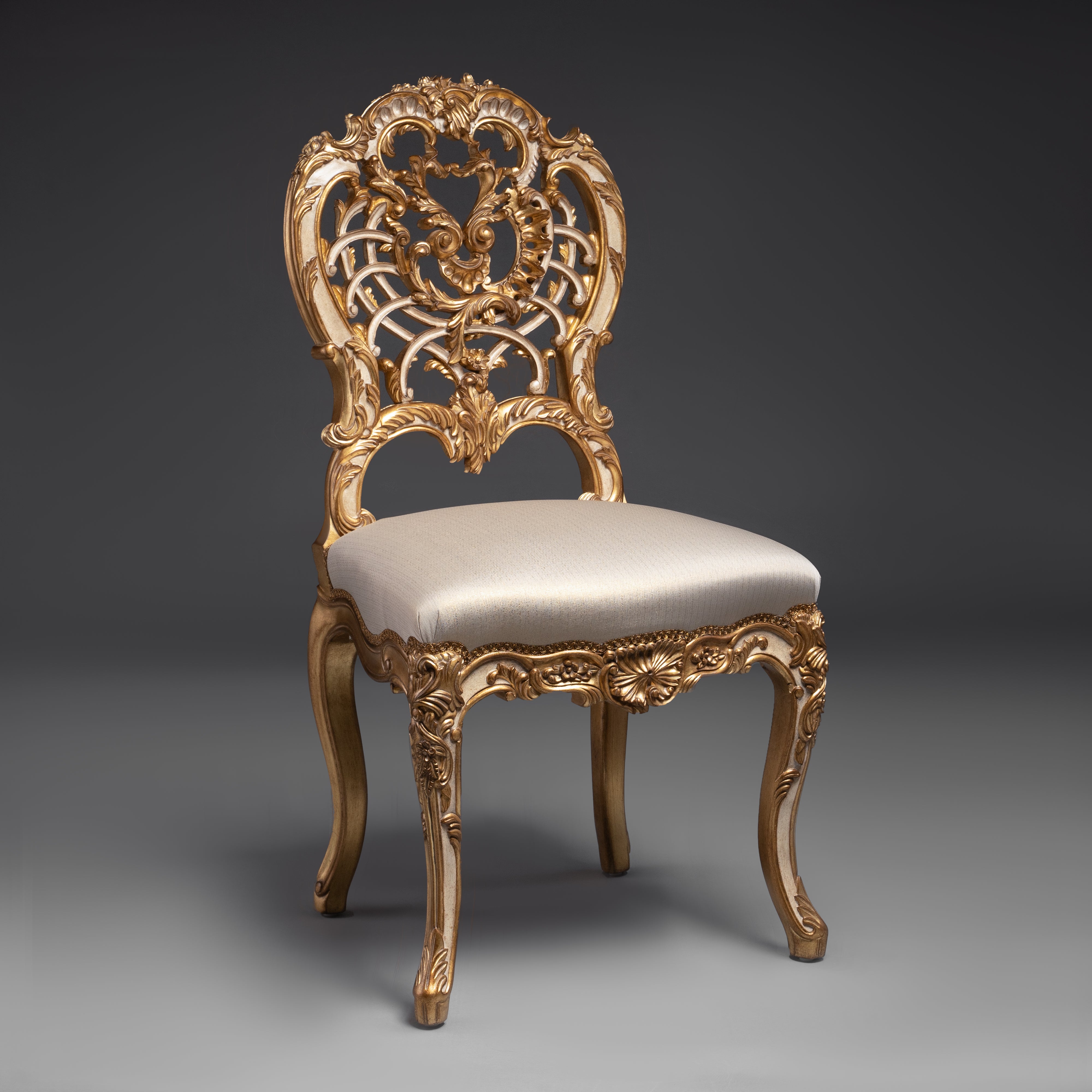 A masterpiece of baroque artistry, this gilded  chair features an intricately carved backrest  with opulent detailing.