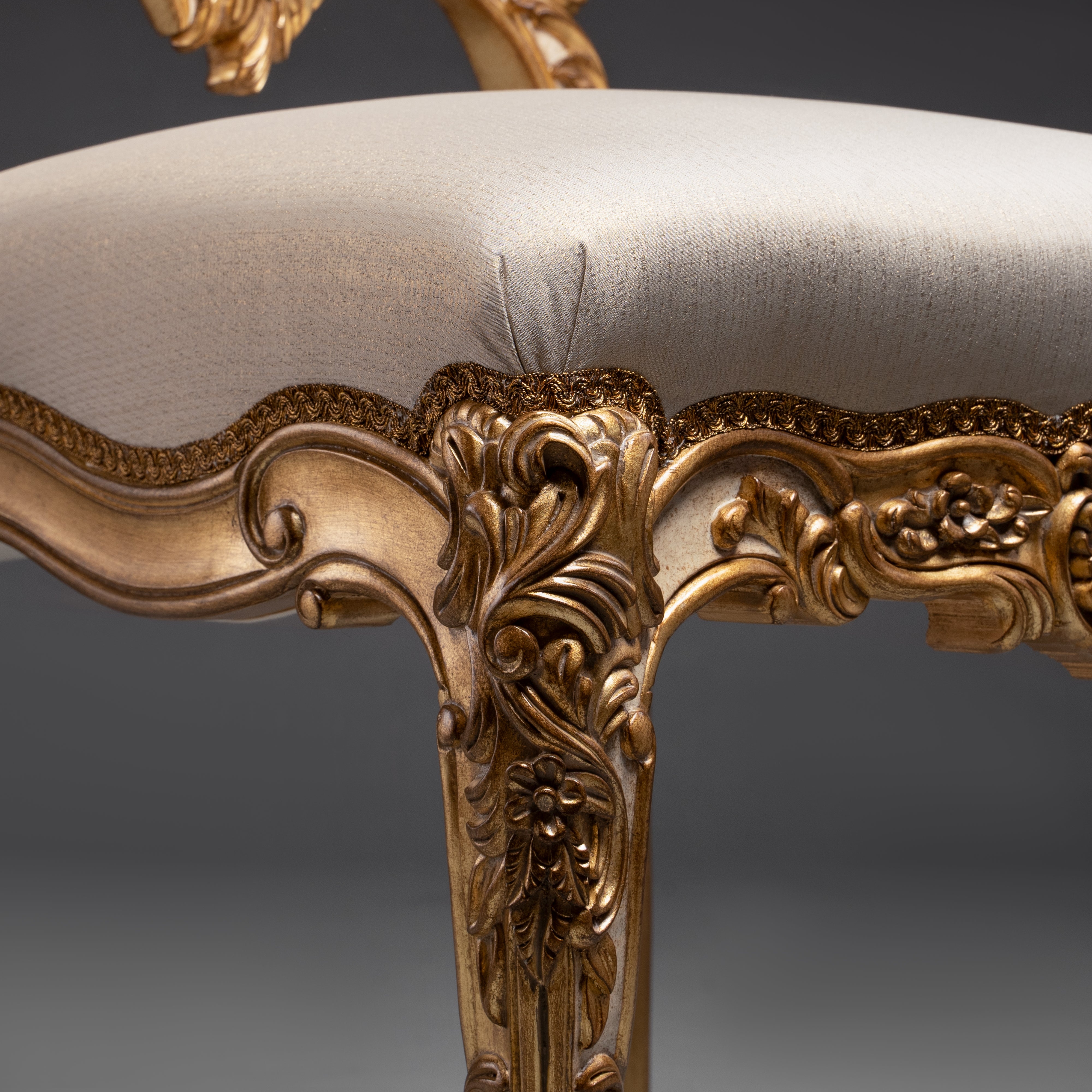 A masterpiece of baroque artistry, this gilded  chair features an intricately carved backrest  with opulent detailing.