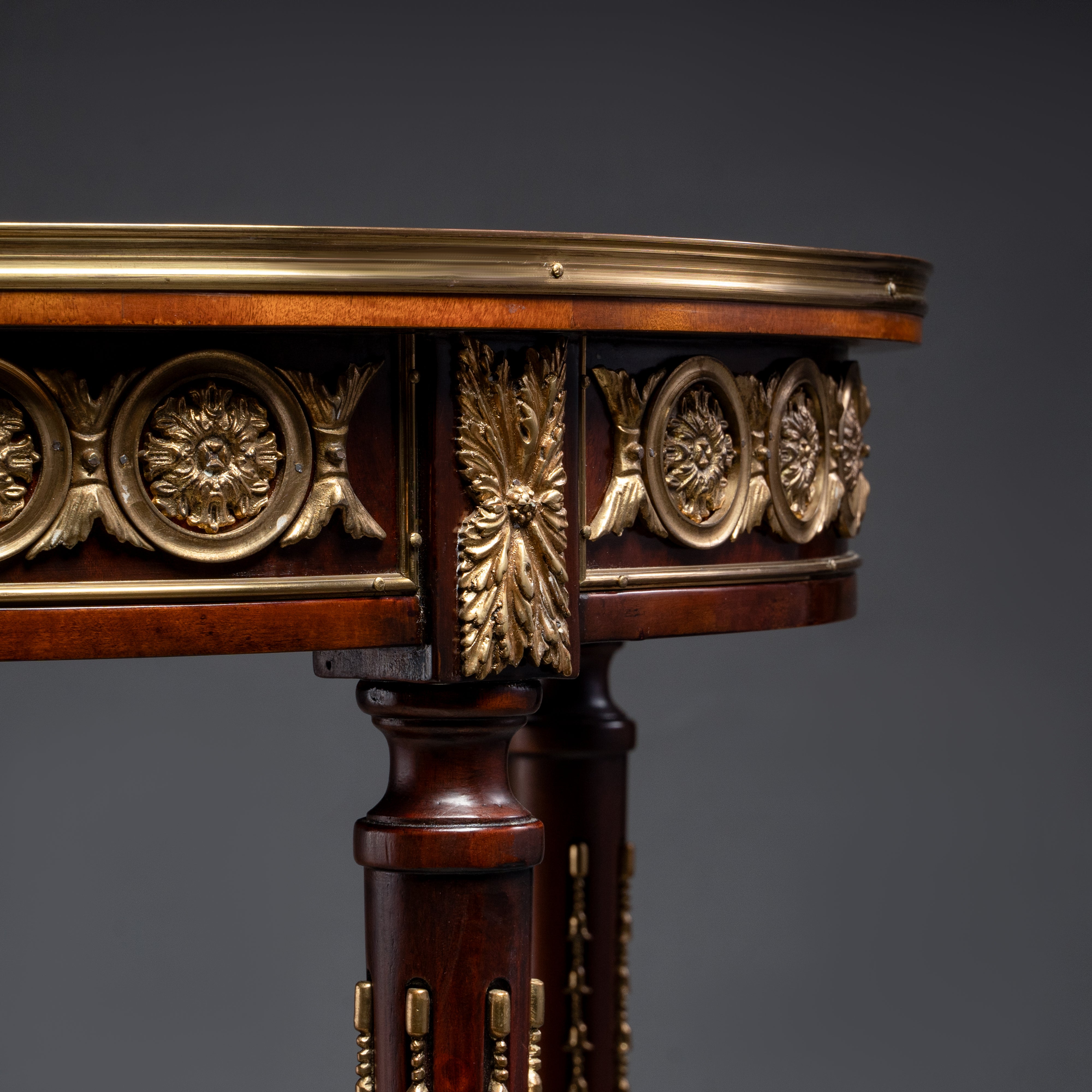 A luxurious round side table featuring  intricate veneer work, elegant brass accents,  and timeless craftsmanship.