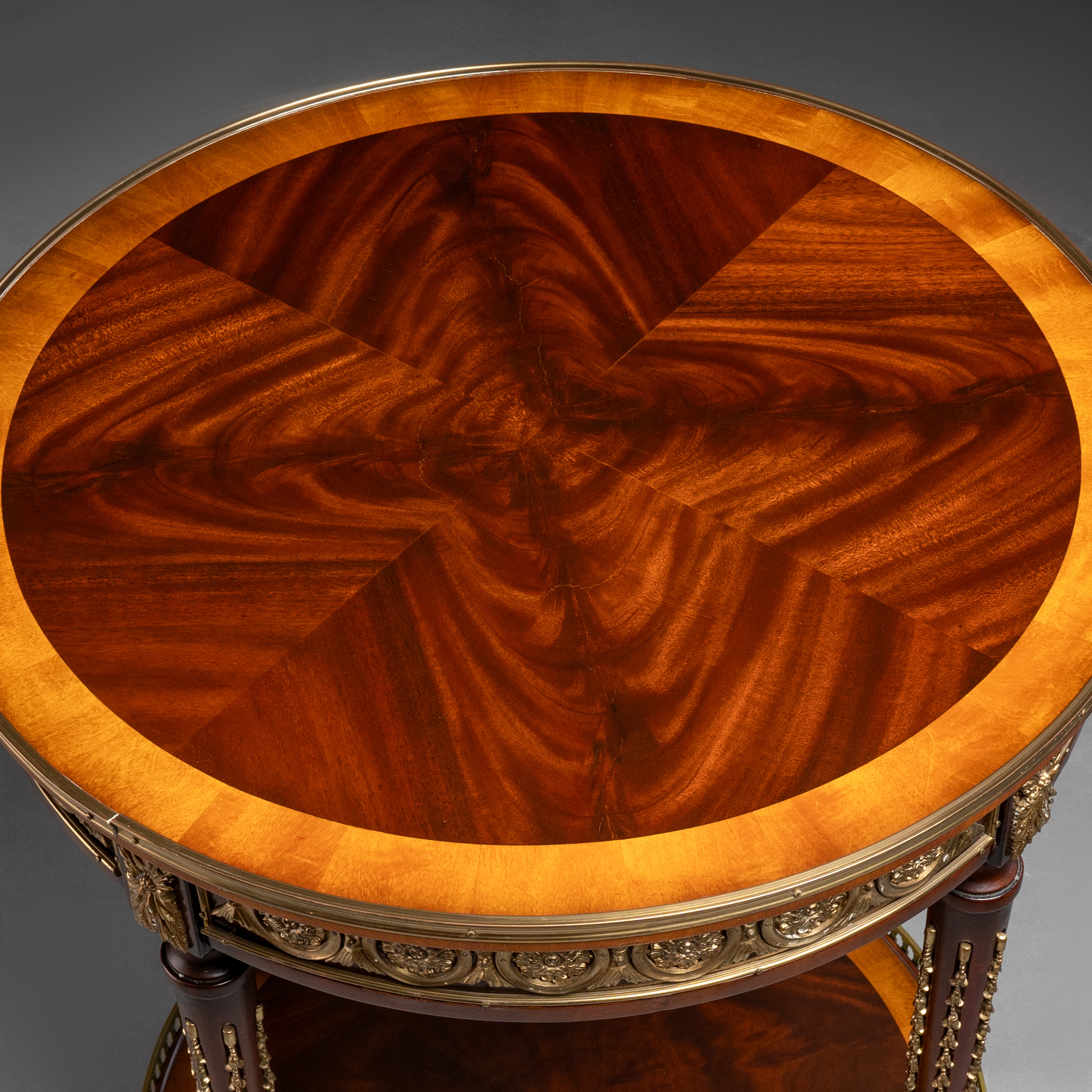 A luxurious round side table featuring  intricate veneer work, elegant brass accents,  and timeless craftsmanship.