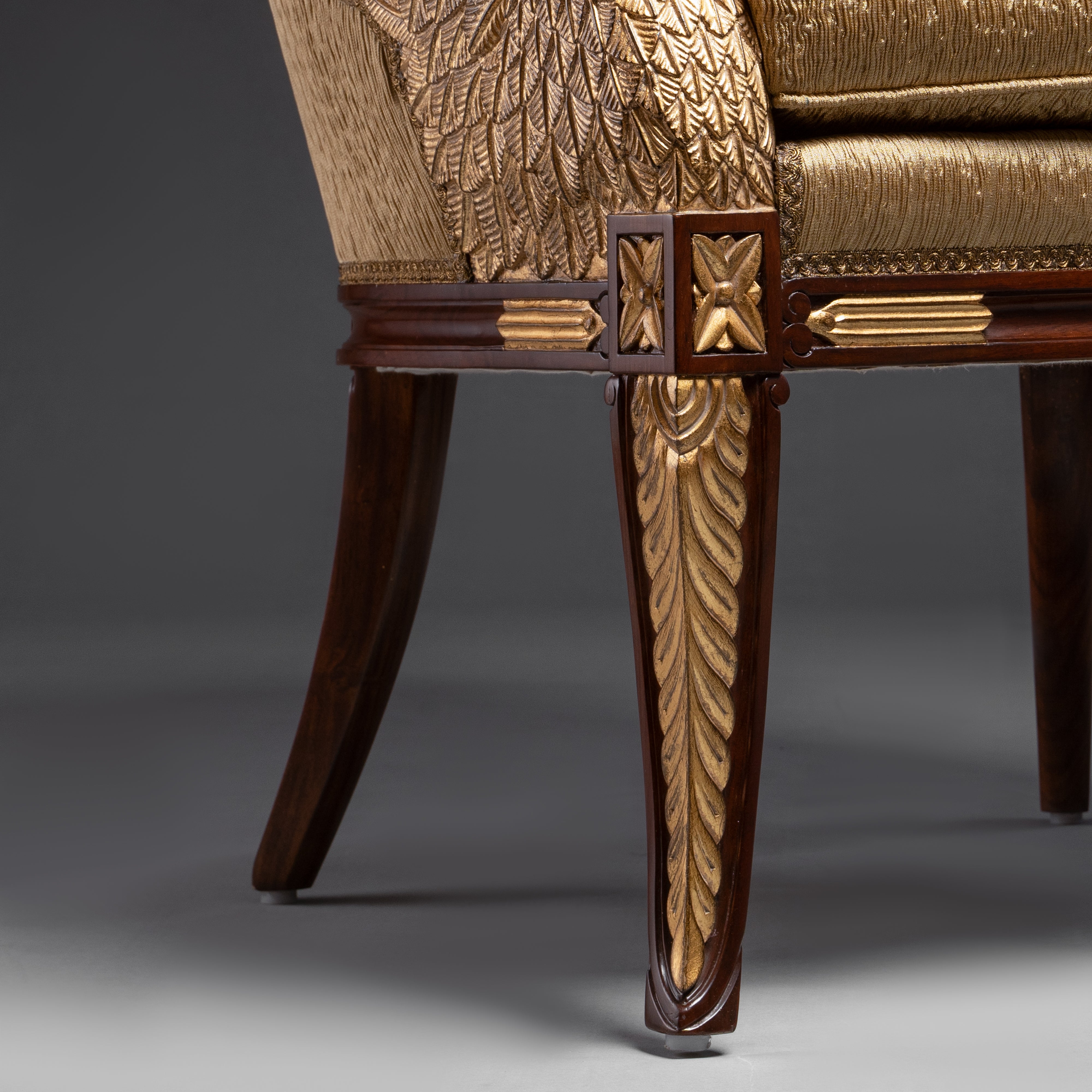A regal Empire-style armchair featuring  exquisitely carved and gilded swan motifs,  embodying timeless elegance.