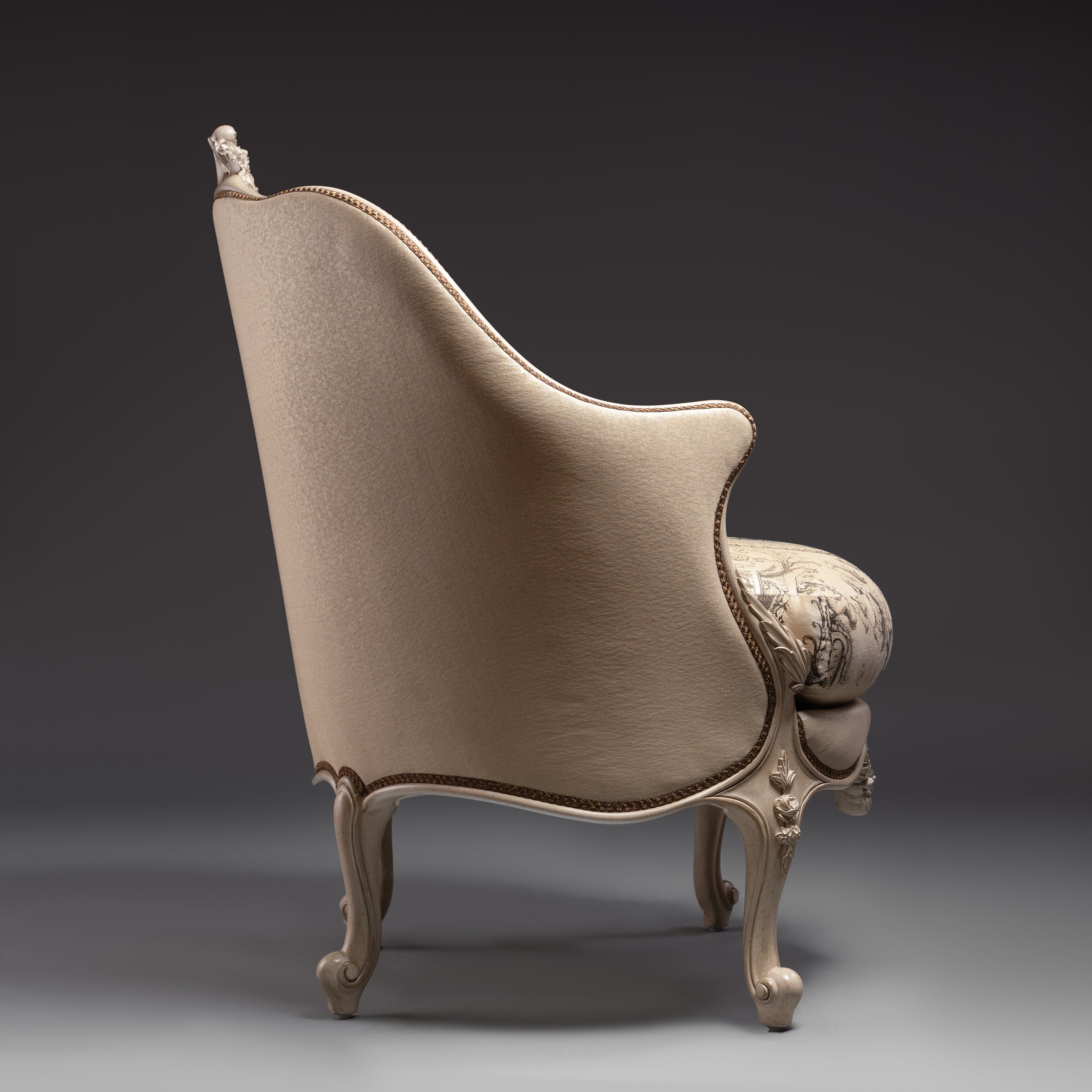 An exquisite Louis XV-style bergère with  intricate carvings and elegant toile de Jouy  upholstery.