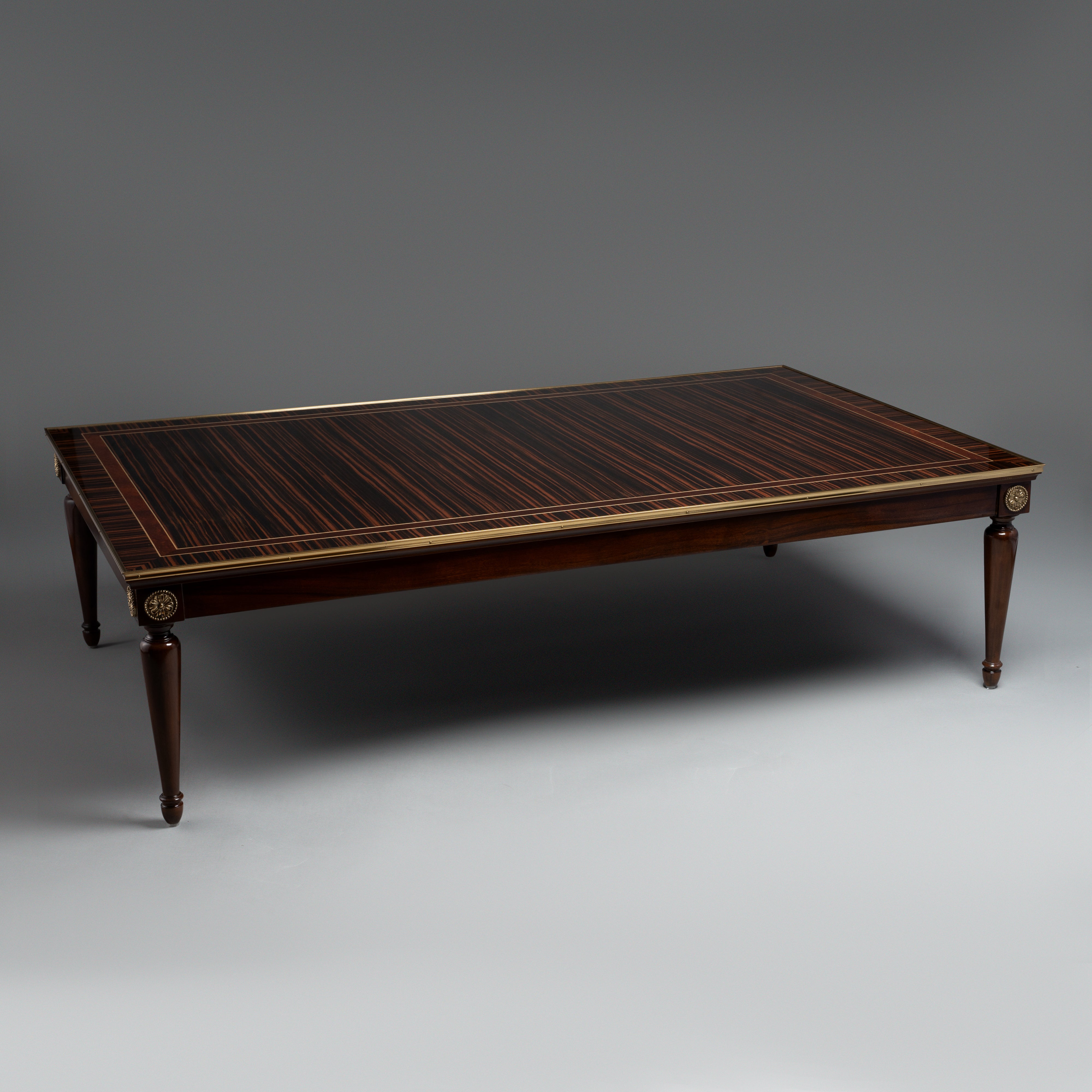 Elegant Coffee Table with Dark Wood Veneer,  Brass Inlay, and Tapered Legs