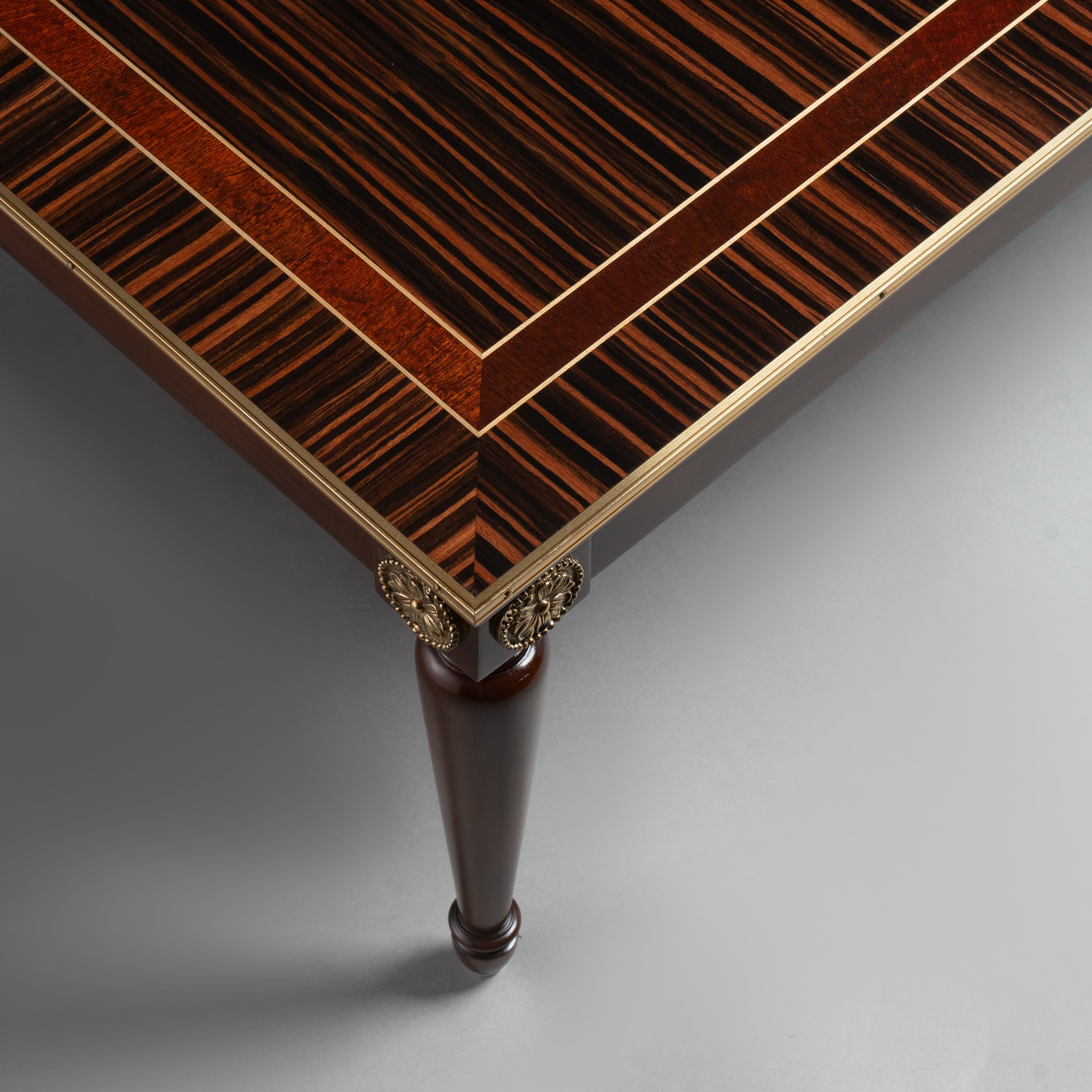 Elegant Coffee Table with Dark Wood Veneer,  Brass Inlay, and Tapered Legs