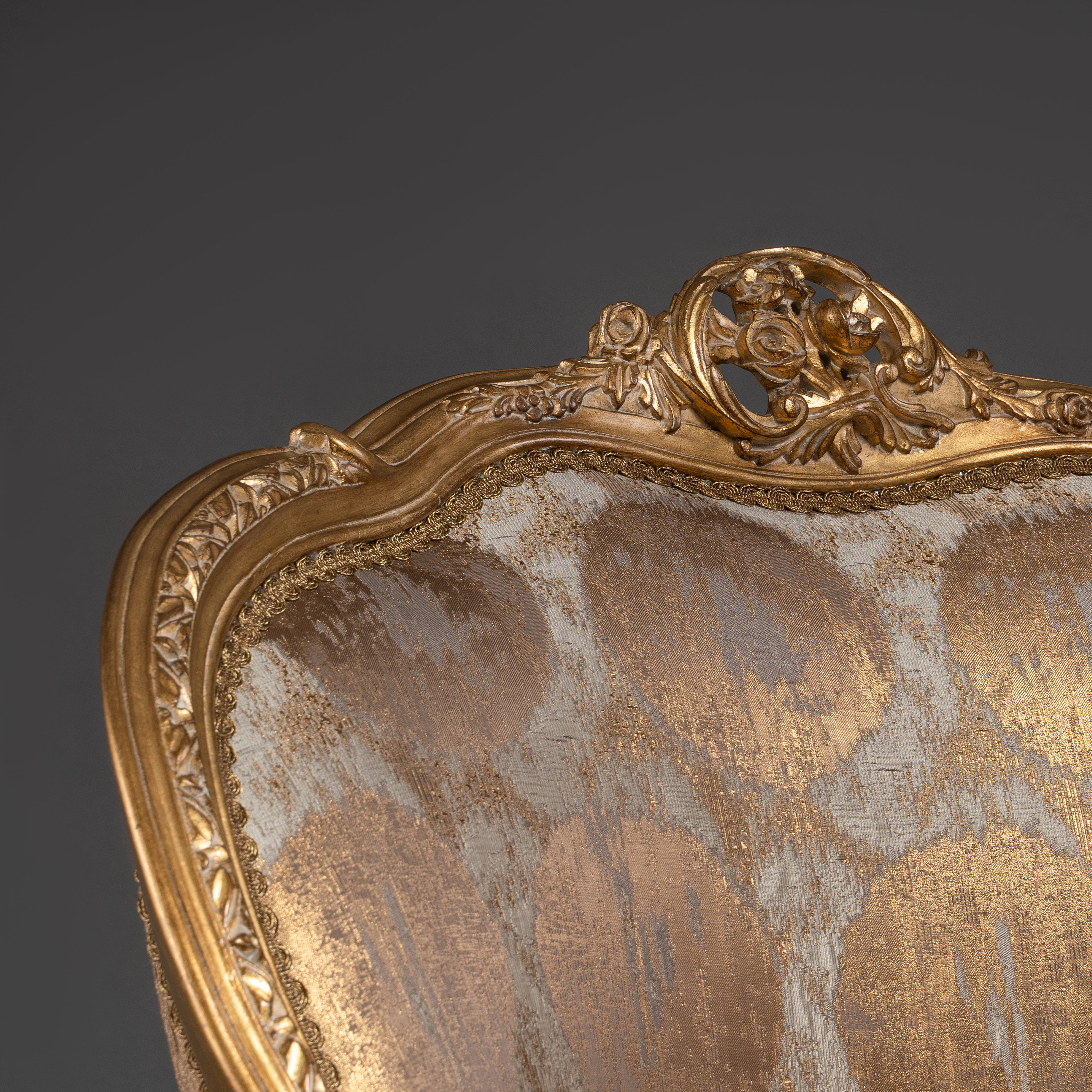 A lavishly upholstered Louis XV-style  armchair with gilded elegance