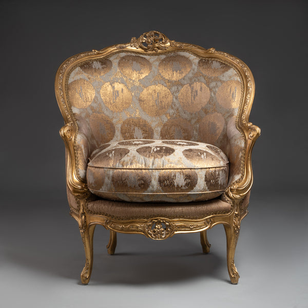 A lavishly upholstered Louis XV-style  armchair with gilded elegance