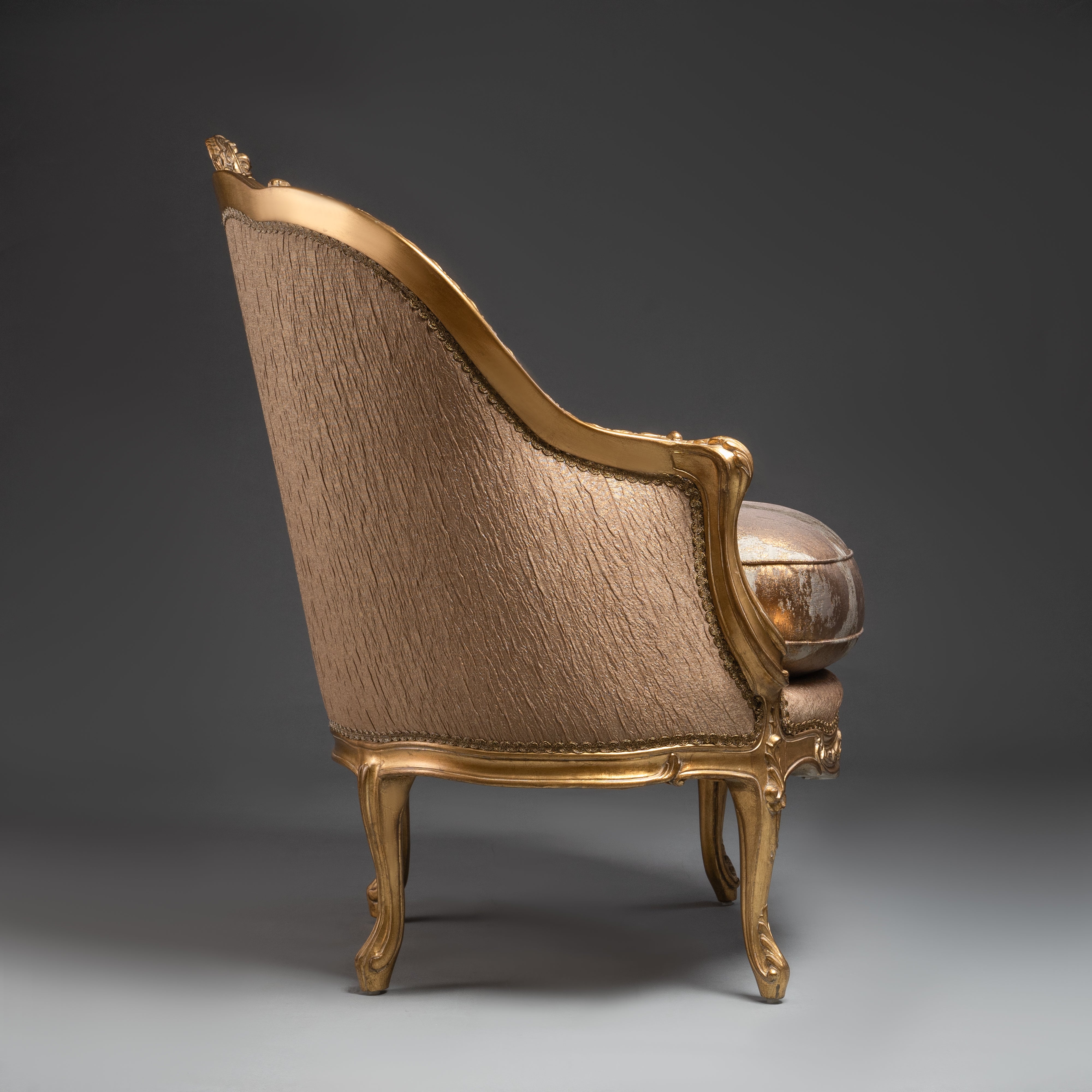 A lavishly upholstered Louis XV-style  armchair with gilded elegance