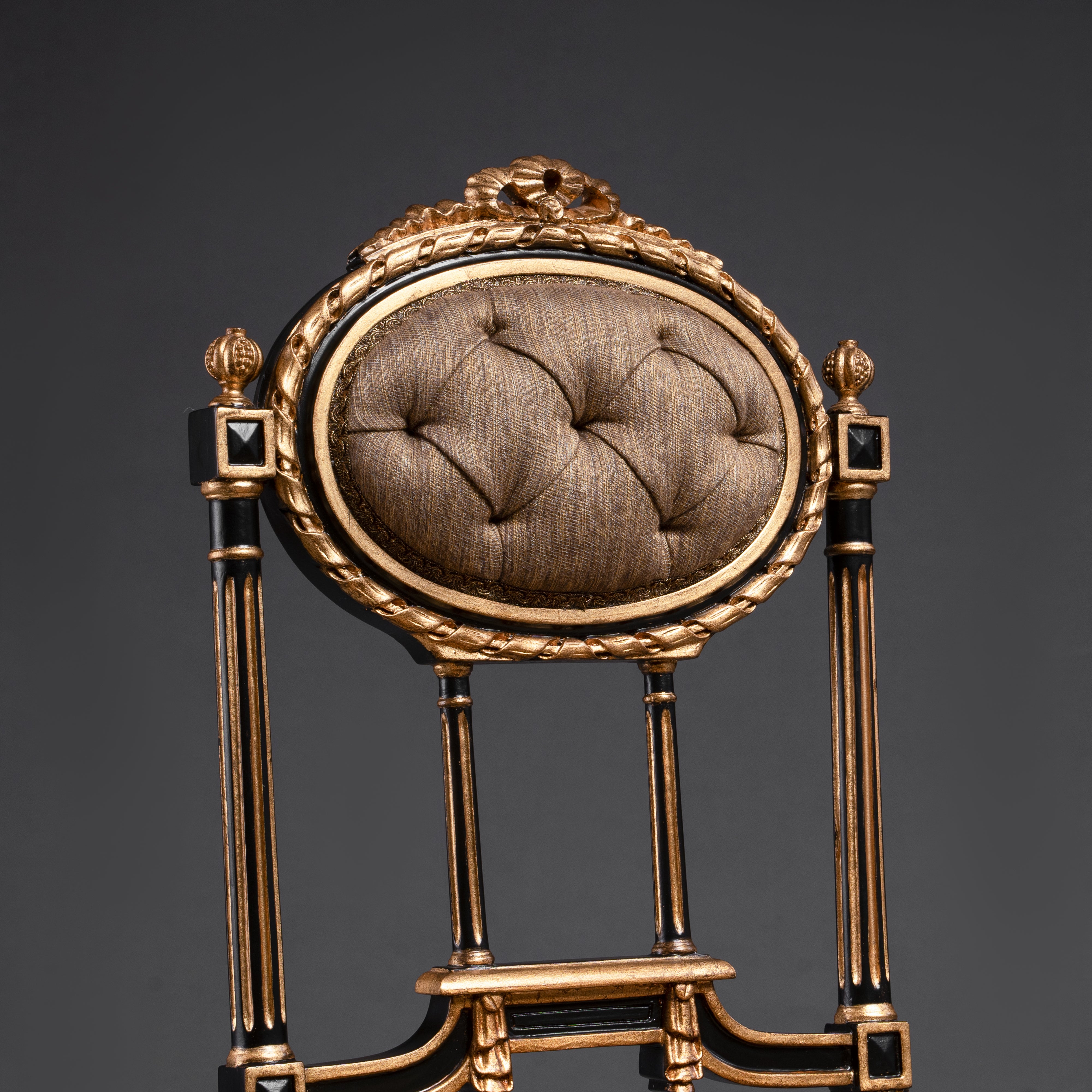 Opulent tufted chair with gilded accents and  regal charm.