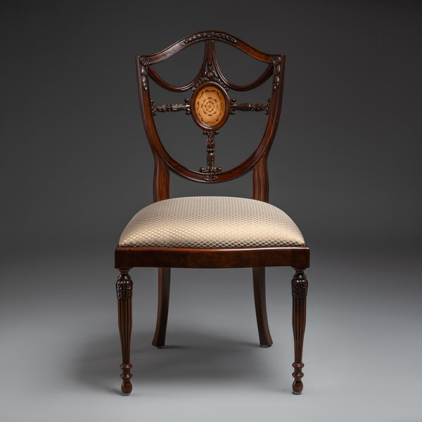 Regal Hepplewhite-shield back chair with  exquisite carvings and luxurious upholstery