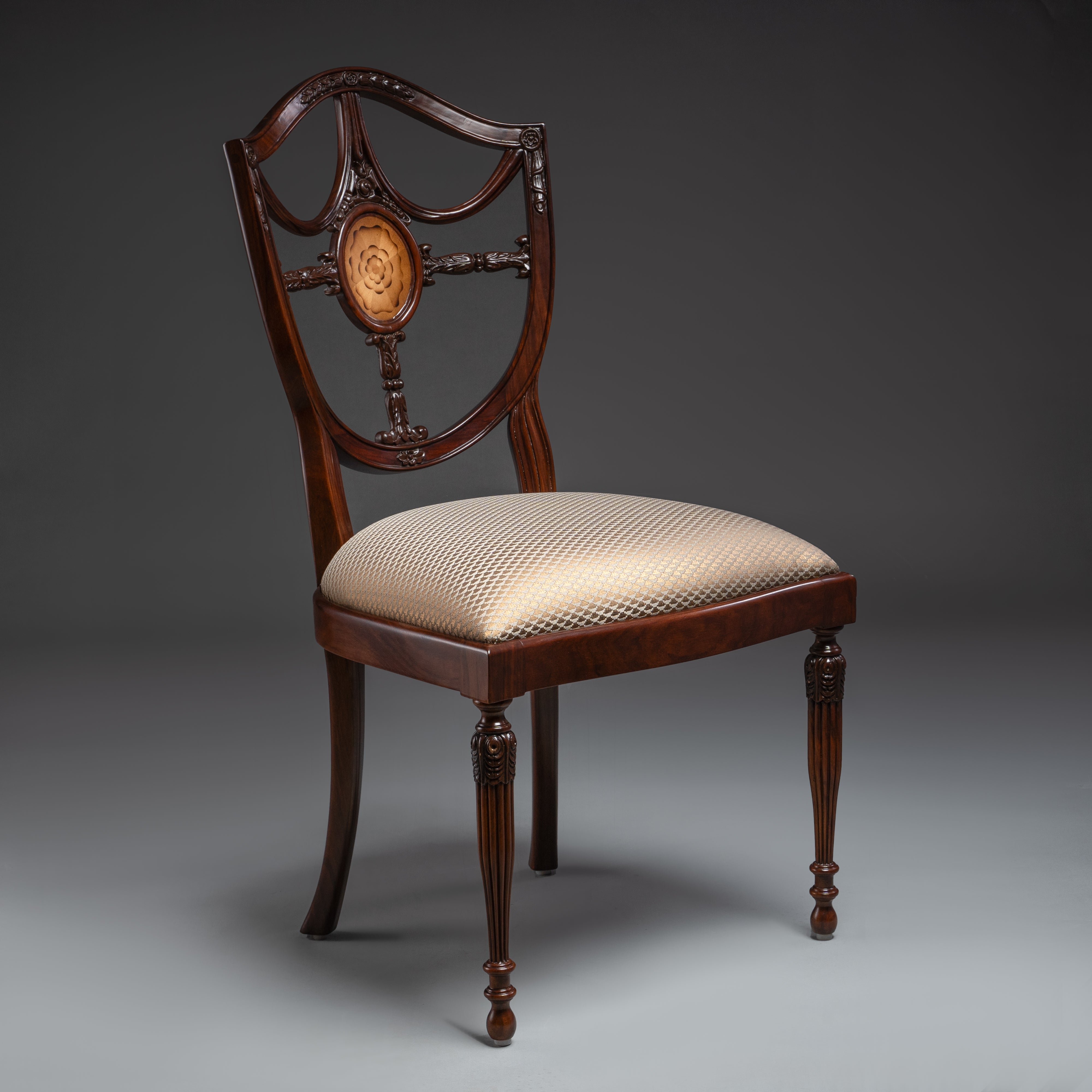 Regal Hepplewhite-shield back chair with  exquisite carvings and luxurious upholstery
