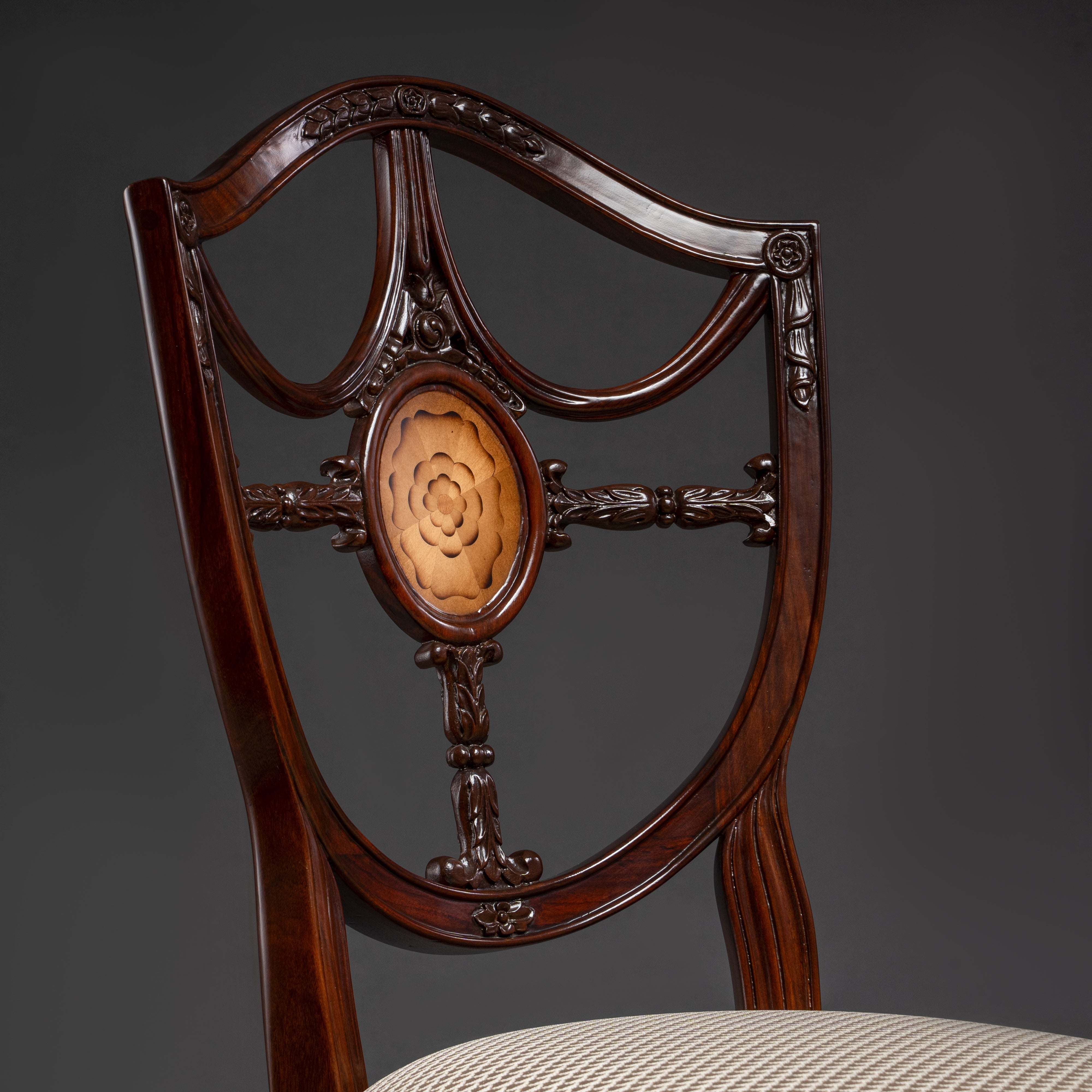 Regal Hepplewhite-shield back chair with  exquisite carvings and luxurious upholstery