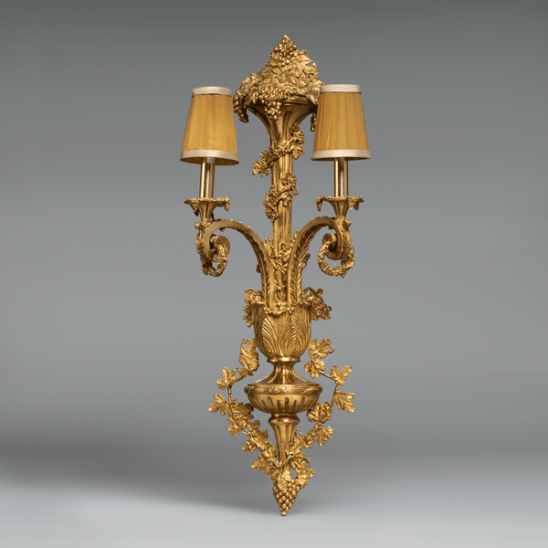 Ornate Louis XVI-style gilt bronze wall sconce  with intricate acanthus and floral motifs