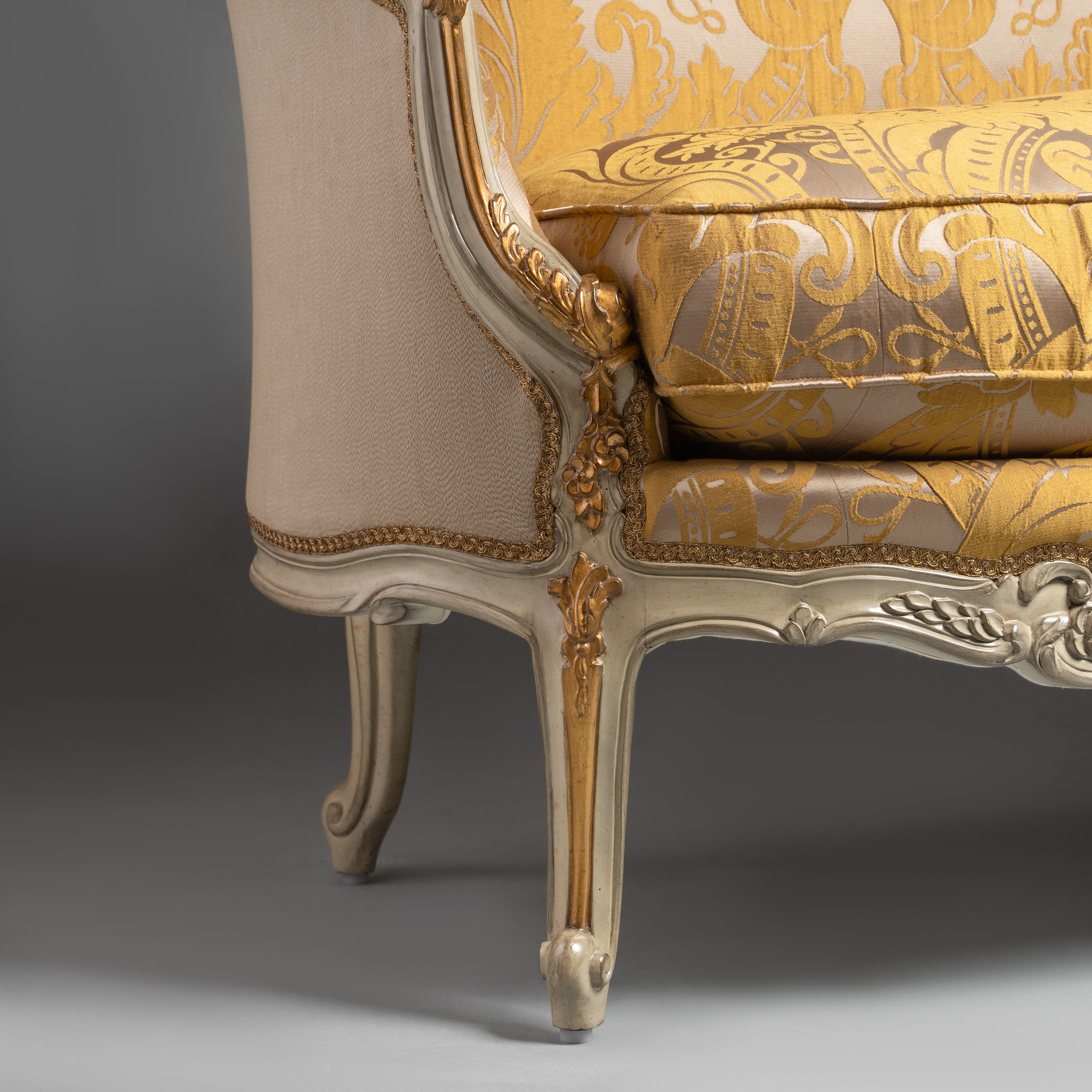 A luxurious Louis XV-style sofa with intricate  carvings and opulent gold damask  upholstery.