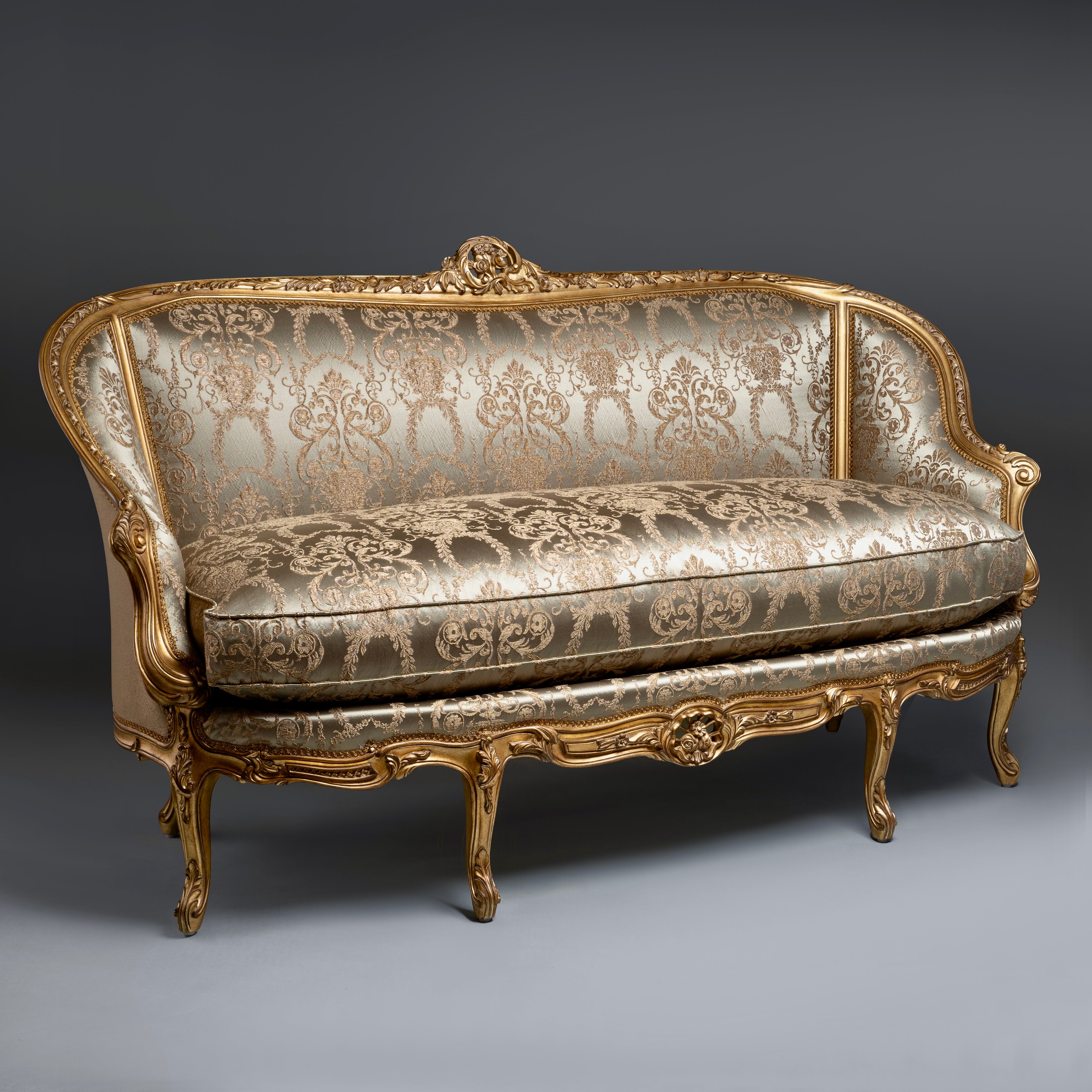 A timeless Chesterfield sofa with luxurious  tufted leather and elegantly rolled arms.