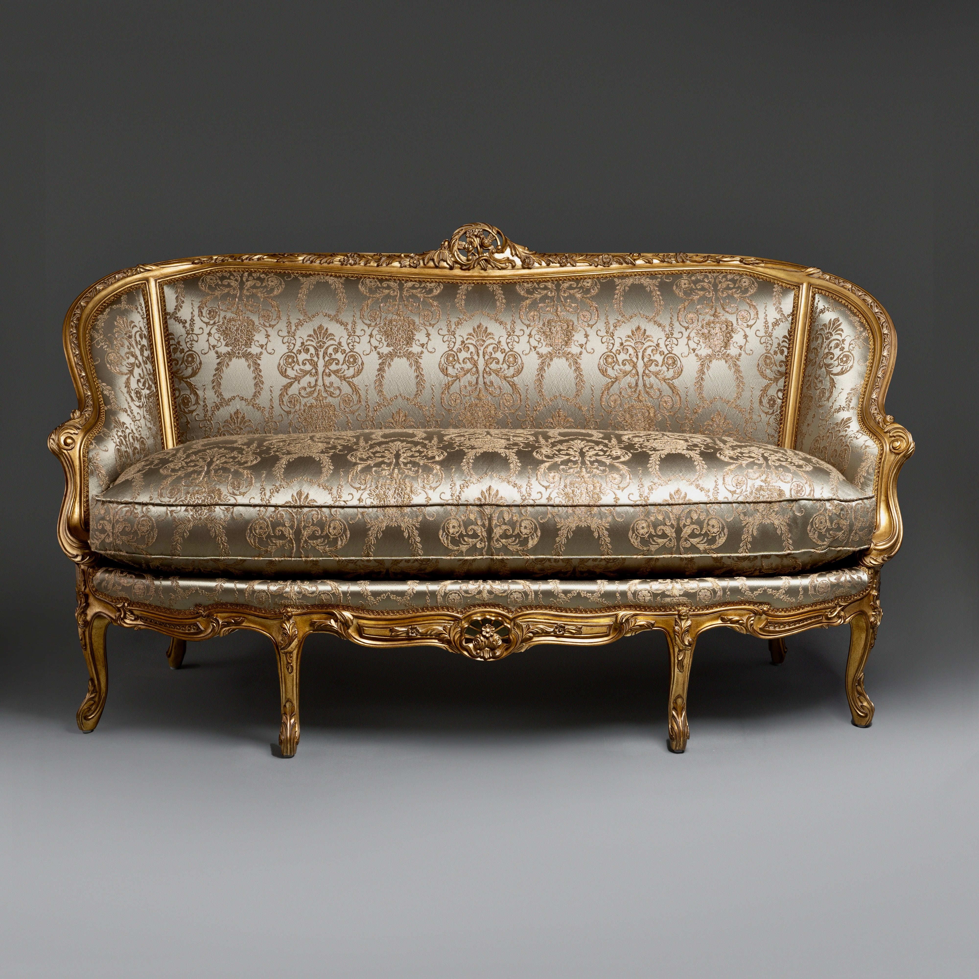 A timeless Chesterfield sofa with luxurious  tufted leather and elegantly rolled arms.