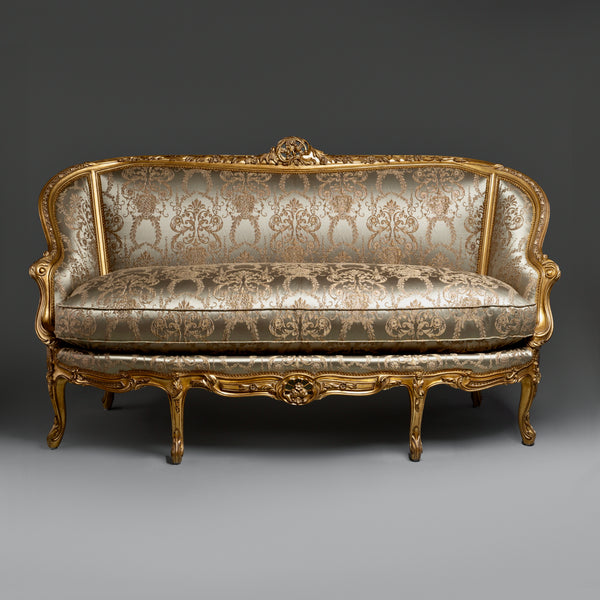 A timeless Chesterfield sofa with luxurious  tufted leather and elegantly rolled arms.