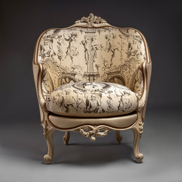 An exquisite Louis XV-style bergère with  intricate carvings and elegant toile de Jouy  upholstery.