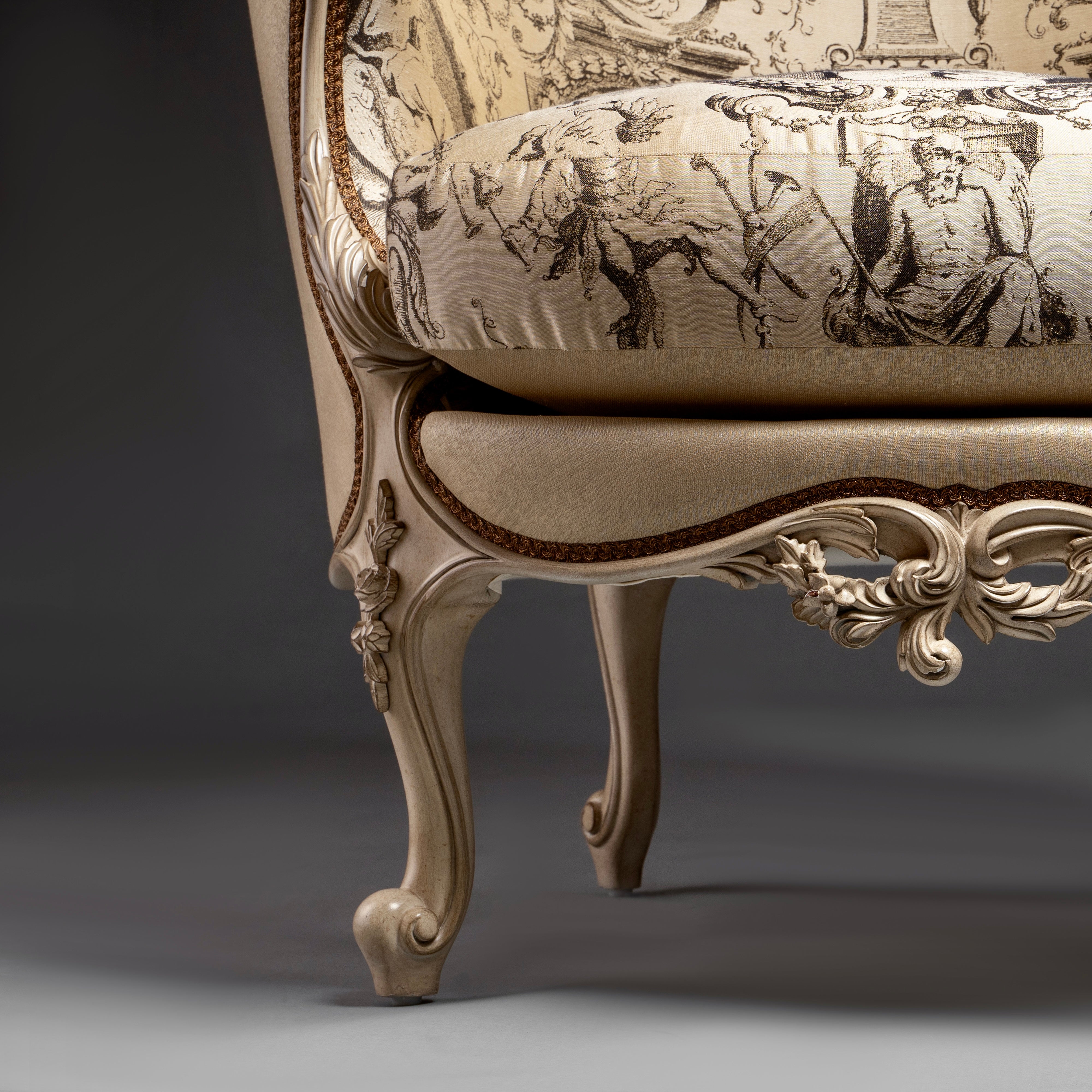 An exquisite Louis XV-style bergère with  intricate carvings and elegant toile de Jouy  upholstery.